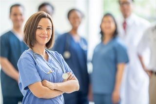A group of nurses stand together and pose.